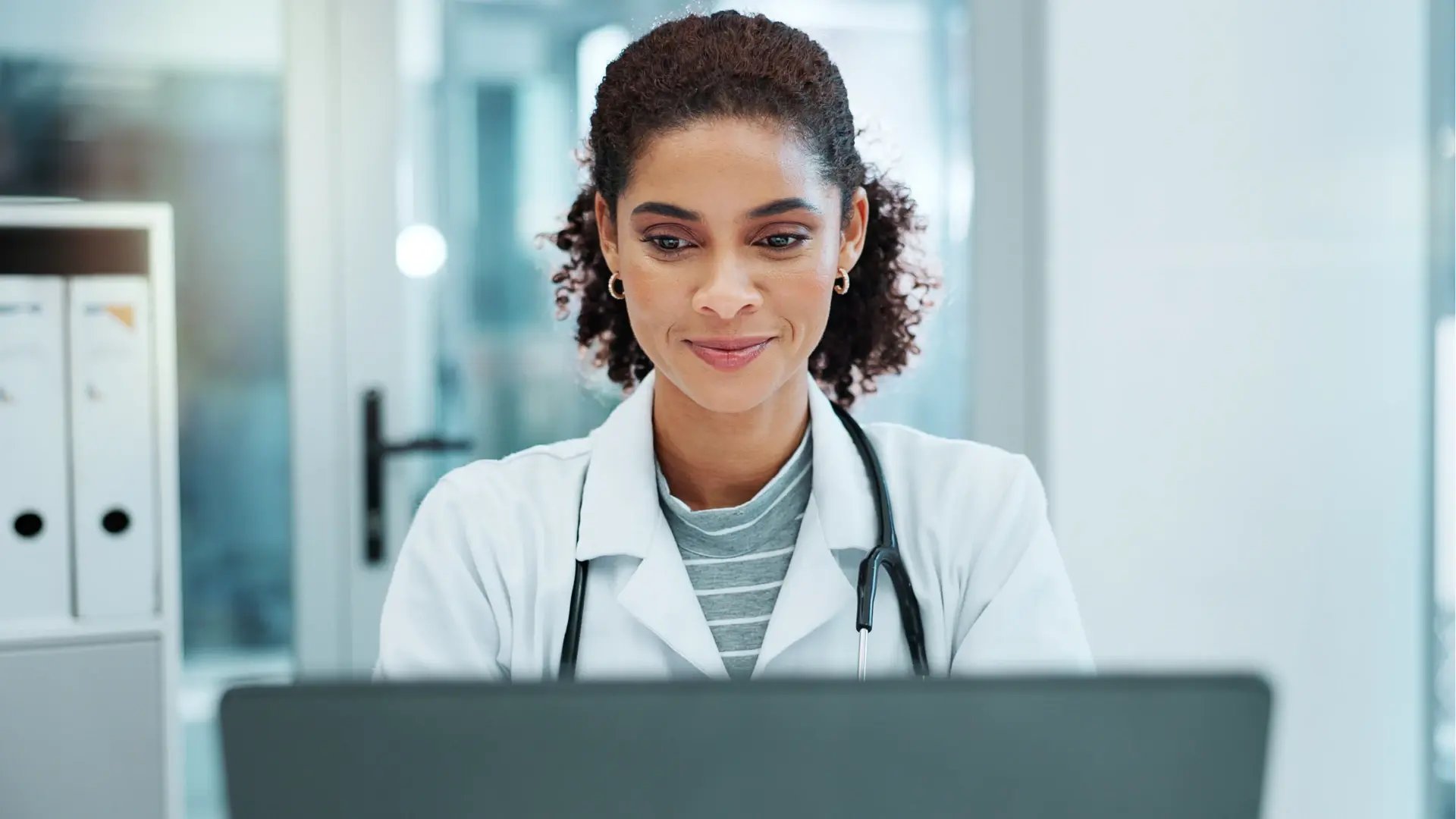 Doctor using laptop_Healthcare claims, billing and payments_Altron HealthTech